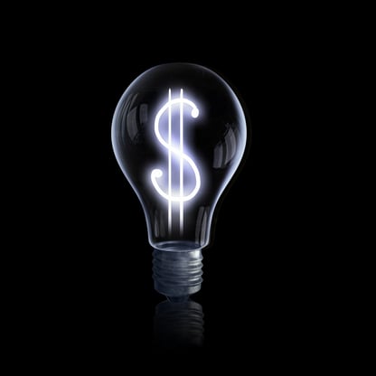 Light bulb with dollar symbol on dark background