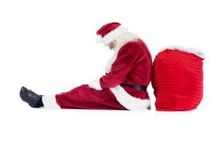 Santa sits leaned on his bag on white background and sleeps.jpeg