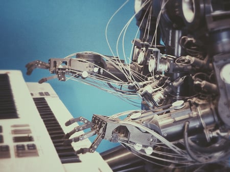 Robot playing keyboard - image from Unsplash